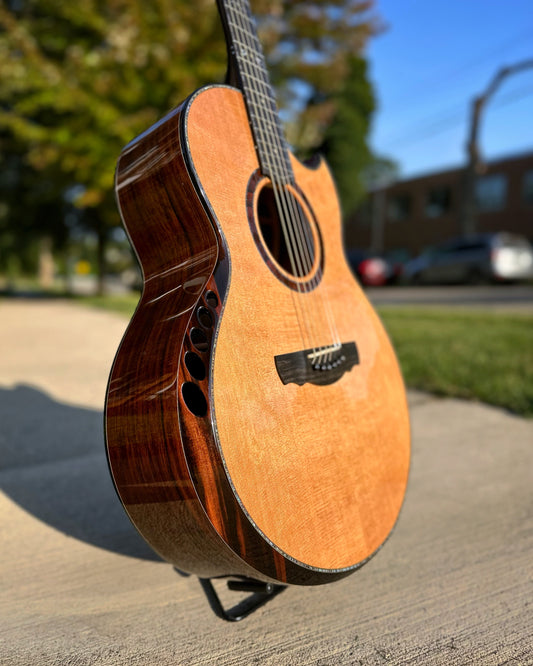 Showroom photo of Front and side of Kevin Ryan Nightingale Grand Soloist Acoustic Guitar 