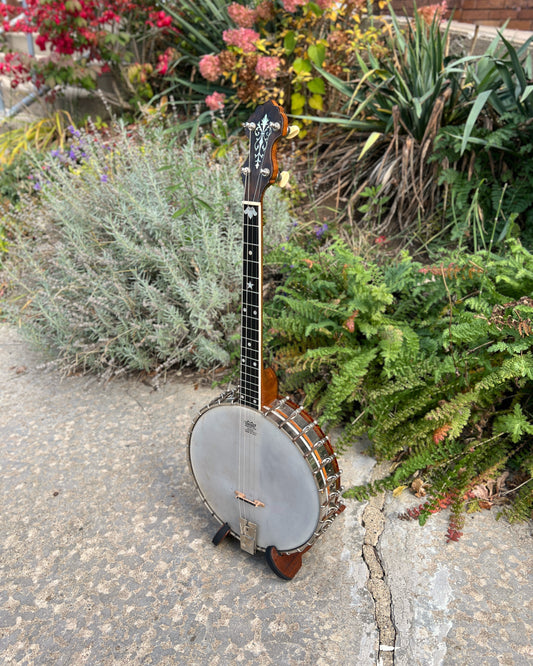 showroom photo of Full front and side of Vega Tubaphone Style M Tenor Banjo (1923)