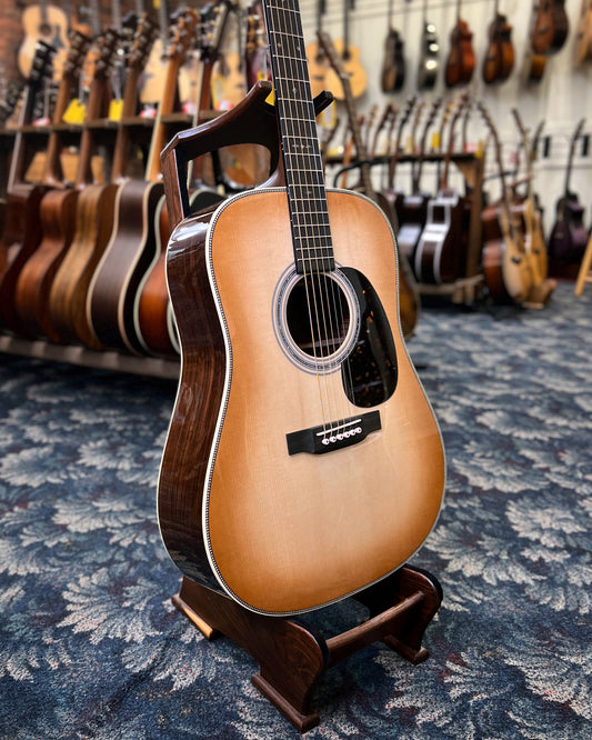 Showroom photo of Front and side of Martin Custom Dreadnought, Herringbone 28-Style - Wild Grain Rosewood & Adirondack Spruce, Toast Burst