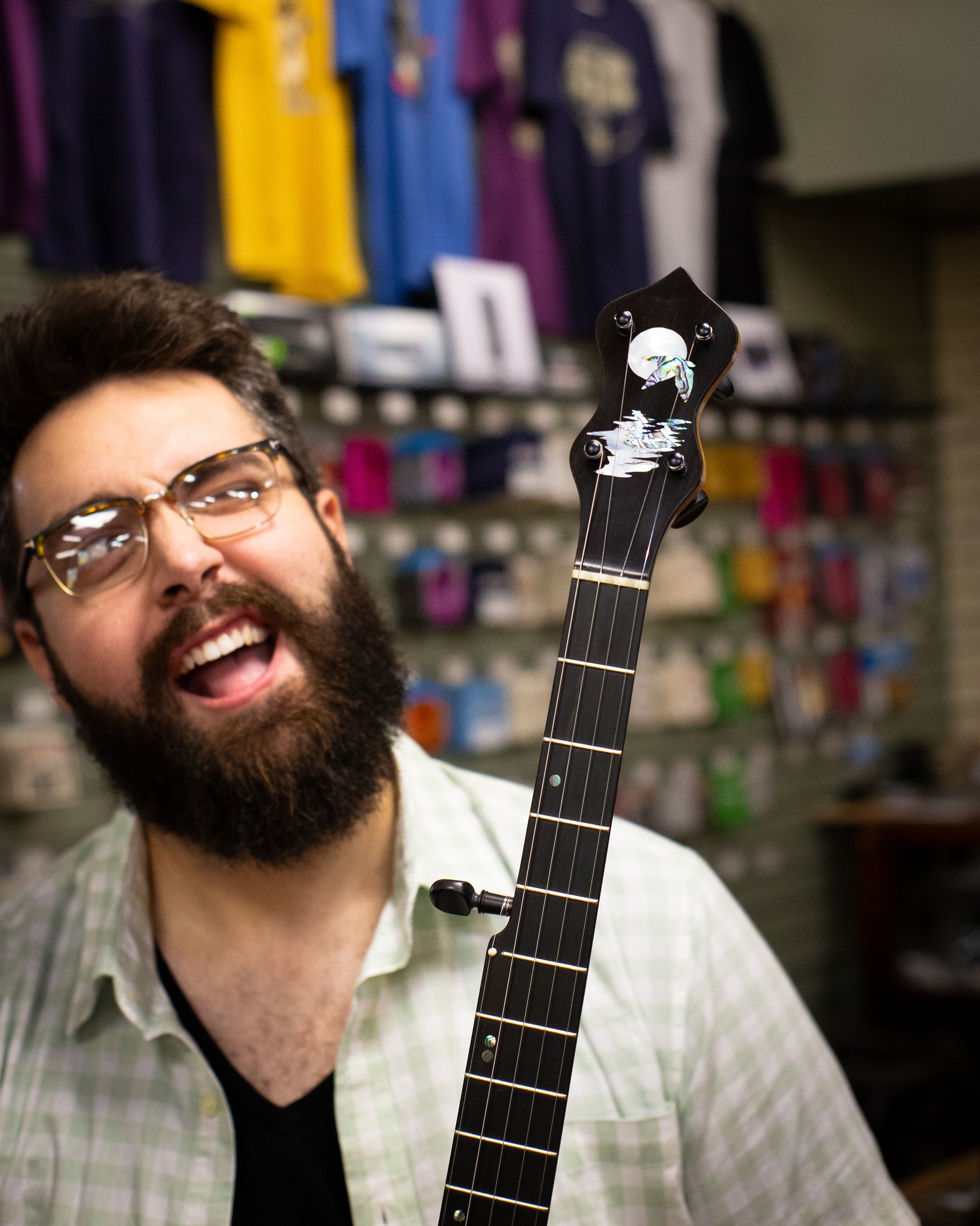 Showroom photo of headstock of Chuck Lee Prairieville Openback Banjo #861, 12" Rim, Brass Hoop Tone Ring