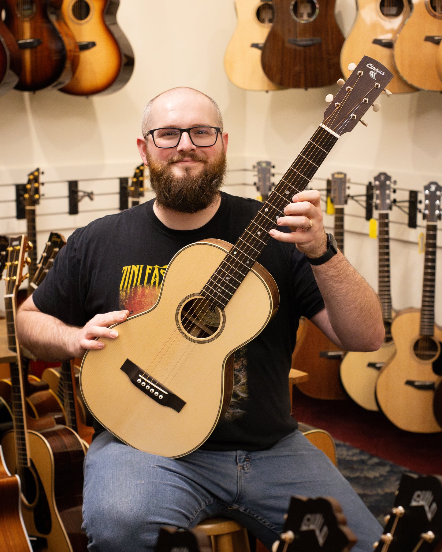 Showroom photo of Cirrus Flamed Walnut Parlor Guitar & Case